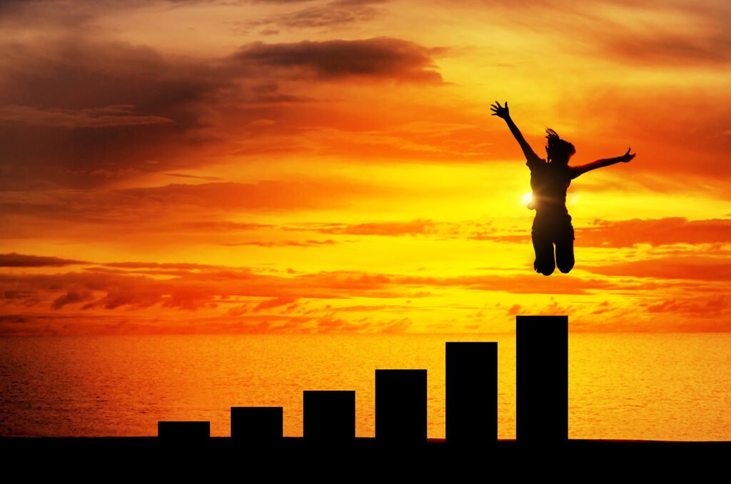 Silhouette of a lady jumping high up through step-wise representation of personal growth