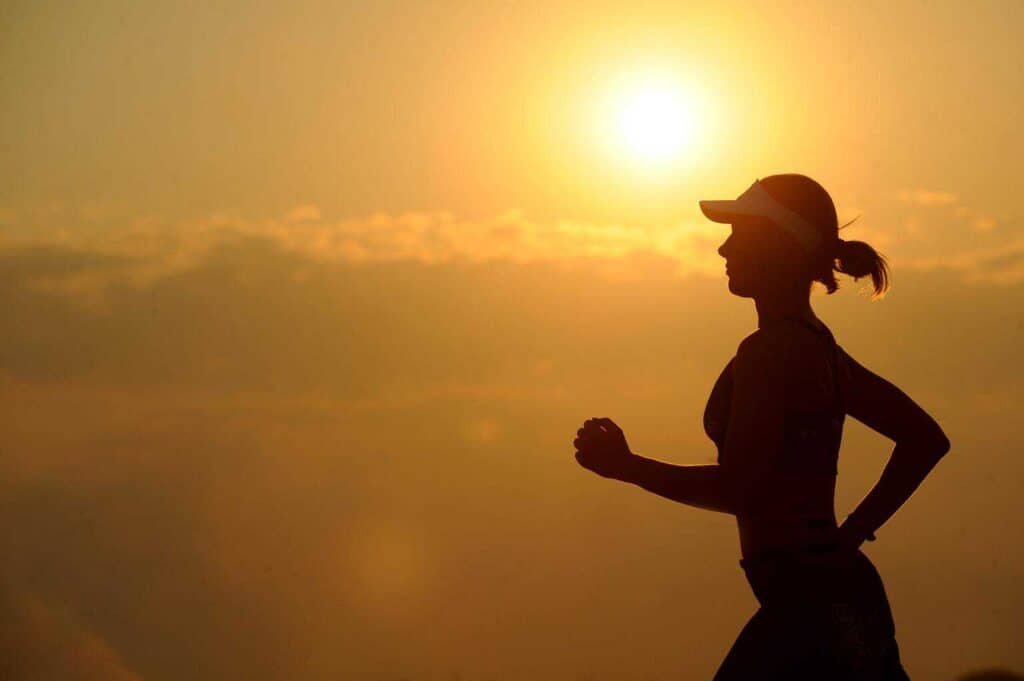 The silhouette of a lady jugging during sunrise to control her migraine headaches 