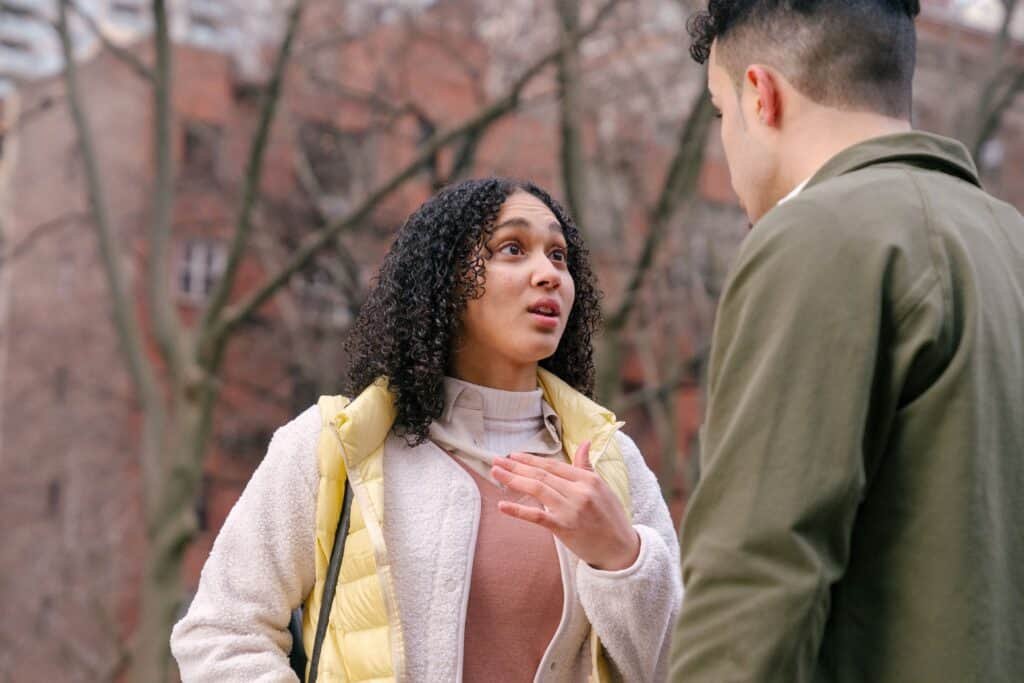 A young couple staring into each other's eyes while engaged in a conversation to rekindle the love in their marriage