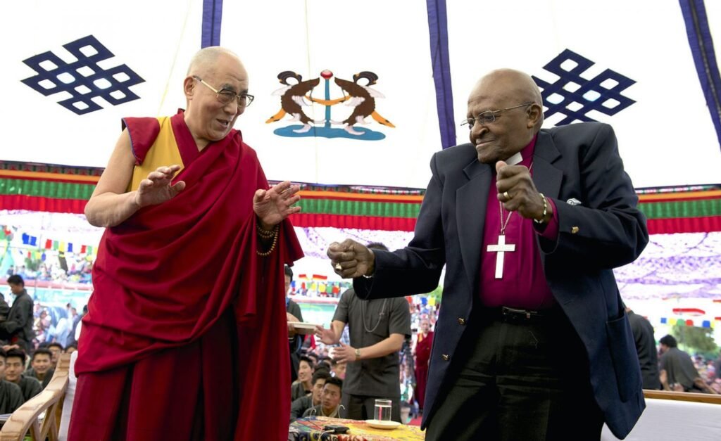 Dalai Lama and Desmond Tutu dancing in a public event to mark Dalai Lama's birthday