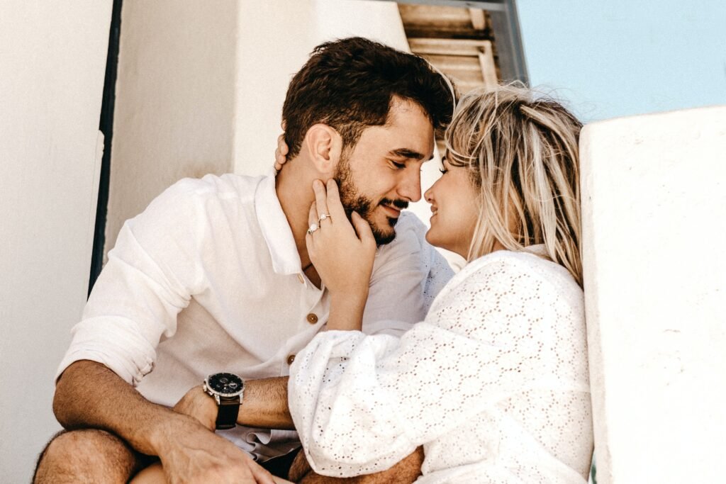 A young couple is smiling and gazing into each other's eyes, content to meet their physical needs in marriage.