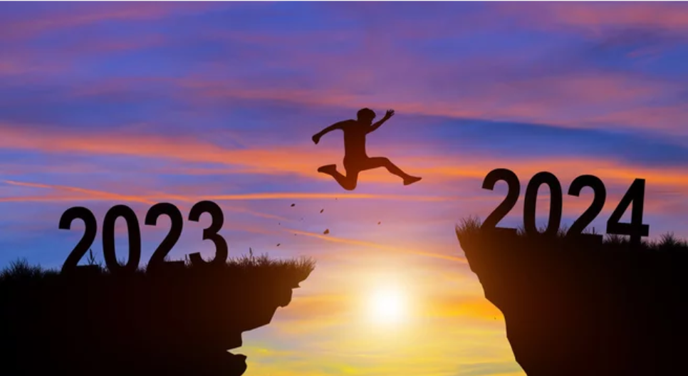 A man jumping from the peak of 2023 to 2024 after conducting a year end review.