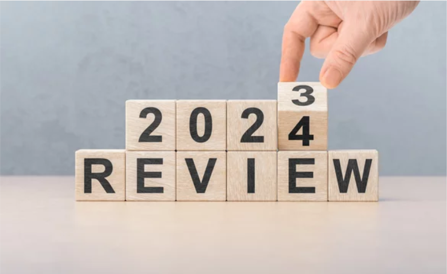 A man turning the blocks of 2023 to 2024 during his year end review