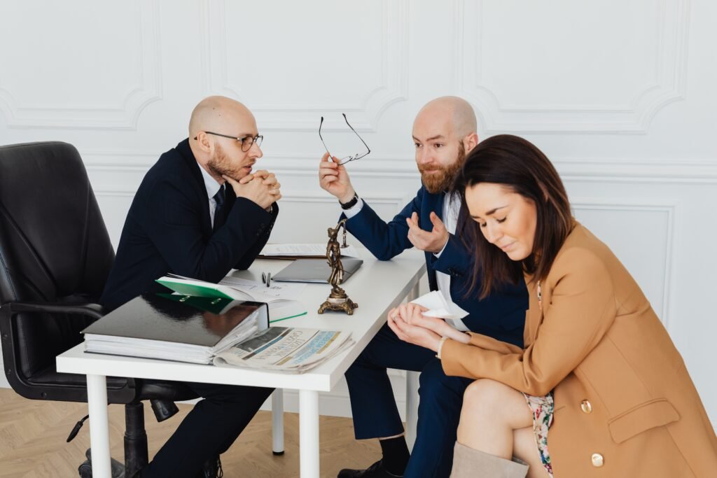 A lawyer consulting with a couple going through breakdown of marriage.