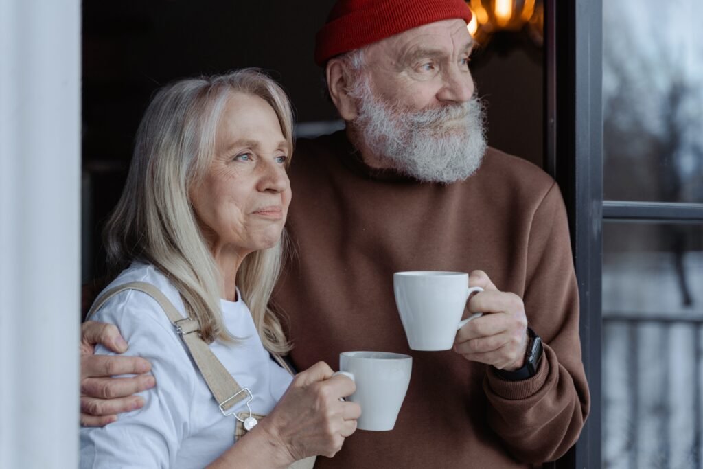 Older couple drinking coffee happily gazing into the future with joy.