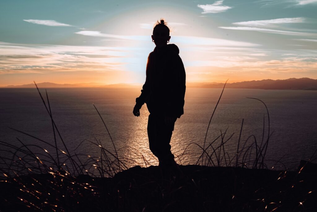 a man gazing at a beautiful sunset near the beach