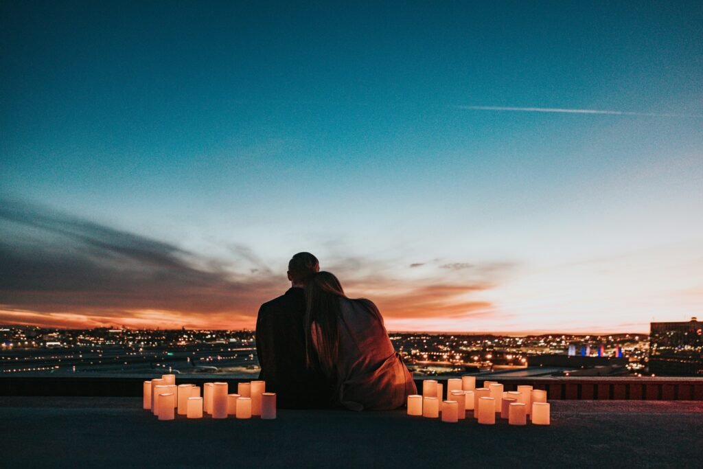 A couple enjoys the sunset surrounded by lit candles at Mumbai during the Divali festival of light.